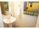 Charming powder room with pedestal sink and decorative accents at 4810 Glenmist Ct, Raleigh, NC 27612