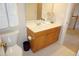Bright bathroom with a white sink, wood drawers and mirrored wall cabinet at 4810 Glenmist Ct, Raleigh, NC 27612