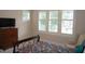 Bedroom with white shutters, a floral print bedspread and dark wood dresser at 4810 Glenmist Ct, Raleigh, NC 27612