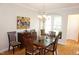 Elegant dining room with hardwood floors, chandelier, and window seat at 4810 Glenmist Ct, Raleigh, NC 27612