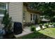 Side exterior view of home featuring tan siding and an outdoor patio area at 4810 Glenmist Ct, Raleigh, NC 27612