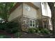 Landscaped side view of home showing brickwork and surrounding greenery at 4810 Glenmist Ct, Raleigh, NC 27612