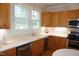 Well-lit kitchen with ample counter space, wood cabinets, and stainless steel appliances at 4810 Glenmist Ct, Raleigh, NC 27612