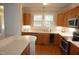 Bright kitchen with wood cabinets, stainless steel appliances, and hardwood floors at 4810 Glenmist Ct, Raleigh, NC 27612