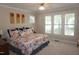 Serene main bedroom with plush carpet, ceiling fan, and shuttered windows at 4810 Glenmist Ct, Raleigh, NC 27612