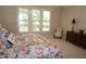 Main bedroom showcasing a large window with shutters and a cozy chair at 4810 Glenmist Ct, Raleigh, NC 27612