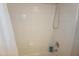 Inside the shower reveals white tiles, shower head and Dove bottle on the floor at 4810 Glenmist Ct, Raleigh, NC 27612