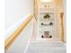 Carpeted stairway with white trim and wood banister leads to built in shelving at 4810 Glenmist Ct, Raleigh, NC 27612