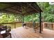 Back deck with a gazebo, seating, a grill, and views of the yard at 517 Wheddon Cross Way, Wake Forest, NC 27587