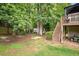 Spacious backyard with stairs leading up to the deck and a lawn mower at 517 Wheddon Cross Way, Wake Forest, NC 27587