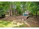Backyard with a deck and seating area surrounded by trees at 517 Wheddon Cross Way, Wake Forest, NC 27587