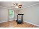 Bedroom with hardwood floors, a treadmill, a ceiling fan and a window at 517 Wheddon Cross Way, Wake Forest, NC 27587