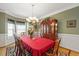 Formal dining room with large chandelier, hardwood floors, and seating for eight at 517 Wheddon Cross Way, Wake Forest, NC 27587