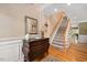 Elegant foyer with wood floors, a staircase, decorative mirror and trim at 517 Wheddon Cross Way, Wake Forest, NC 27587
