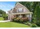 Charming two-story home with stone accents, covered porch, manicured lawn and lush landscaping at 517 Wheddon Cross Way, Wake Forest, NC 27587