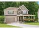 Well maintained traditional home, stone accents, attached garage and mature landscaping at 517 Wheddon Cross Way, Wake Forest, NC 27587