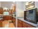 Spacious kitchen featuring granite countertops, warm wood cabinetry, and stainless steel appliances at 517 Wheddon Cross Way, Wake Forest, NC 27587
