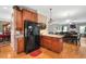 Charming kitchen featuring wood cabinets, granite countertops, and a black refrigerator at 517 Wheddon Cross Way, Wake Forest, NC 27587