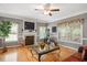Bright living room with a fireplace, large windows, and hardwood floors at 517 Wheddon Cross Way, Wake Forest, NC 27587