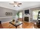 Elegant living room featuring a fireplace, hardwood floors, and neutral tones at 517 Wheddon Cross Way, Wake Forest, NC 27587