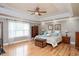 Serene main bedroom featuring a tray ceiling, hardwood floors, and ample space at 517 Wheddon Cross Way, Wake Forest, NC 27587
