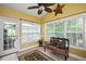 Bright sunroom with tiled floors, large windows, and comfortable seating at 517 Wheddon Cross Way, Wake Forest, NC 27587