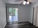 Bedroom featuring a sliding glass door for backyard access, laminate flooring, and a ceiling fan at 5228 Olive Rd, Raleigh, NC 27606