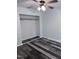 Bright bedroom featuring modern laminate flooring and a closet with an open entry at 5228 Olive Rd, Raleigh, NC 27606
