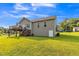Back exterior of a home featuring a wooden deck, stairs, lawn, and back door to a basement at 54 Lockwood Dr, Clayton, NC 27527