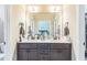 Bathroom features a dual sink vanity, large mirror and views of the bedroom beyond at 54 Lockwood Dr, Clayton, NC 27527