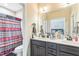 Bathroom with double sink vanity, neutral colors, and a large mirror at 54 Lockwood Dr, Clayton, NC 27527
