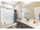 Neutral bathroom featuring a vanity with dark cabinets, with a shower and tub at 54 Lockwood Dr, Clayton, NC 27527