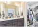 Bathroom featuring a double vanity sink with a view into the closet space at 54 Lockwood Dr, Clayton, NC 27527
