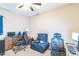 Bedroom with two desks and blue lounge seating, lit by a ceiling fan at 54 Lockwood Dr, Clayton, NC 27527