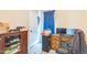 Bedroom with neutral walls, storage cabinet, desk and a blue curtain at 54 Lockwood Dr, Clayton, NC 27527