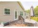 Back deck showcasing a patio table and an umbrella for shade at 54 Lockwood Dr, Clayton, NC 27527
