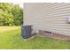 Home exterior featuring a modern HVAC system against a neutral siding backdrop at 54 Lockwood Dr, Clayton, NC 27527