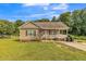 Charming single-story home with a welcoming front porch and well-maintained lawn and landscaping at 54 Lockwood Dr, Clayton, NC 27527