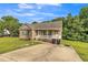 Charming single-story home with a welcoming front porch and well-maintained lawn and landscaping at 54 Lockwood Dr, Clayton, NC 27527