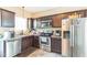 Well-equipped kitchen featuring stainless steel appliances, dark cabinets, and ample counter space at 54 Lockwood Dr, Clayton, NC 27527