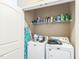 Laundry room showcasing a washer and dryer with shelves holding cleaning supplies at 54 Lockwood Dr, Clayton, NC 27527