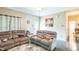 Cozy living room with reclining sofas, hardwood floors, and natural light at 54 Lockwood Dr, Clayton, NC 27527