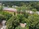 Aerial view of the home near the highway showing a forested neighborhood with easy access at 5520 Kaplan Dr, Raleigh, NC 27606