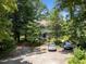 Expansive lot with mature trees offering privacy and plenty of parking space for residents and guests at 5520 Kaplan Dr, Raleigh, NC 27606