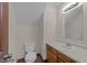 Compact half bathroom with a classic vanity and lighting fixture at 5520 Kaplan Dr, Raleigh, NC 27606