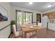 Bright dining room featuring a modern table set and sliding glass doors at 5520 Kaplan Dr, Raleigh, NC 27606