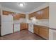 Functional kitchen layout with white appliances and ample cabinet storage at 5520 Kaplan Dr, Raleigh, NC 27606