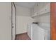 Dedicated laundry room with a washer, dryer, and overhead storage at 5520 Kaplan Dr, Raleigh, NC 27606