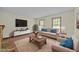 Cozy living room with a brick fireplace, comfortable seating, and a large screen television at 5520 Kaplan Dr, Raleigh, NC 27606