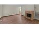 Inviting living room featuring a classic brick fireplace and wood-look flooring at 5520 Kaplan Dr, Raleigh, NC 27606
